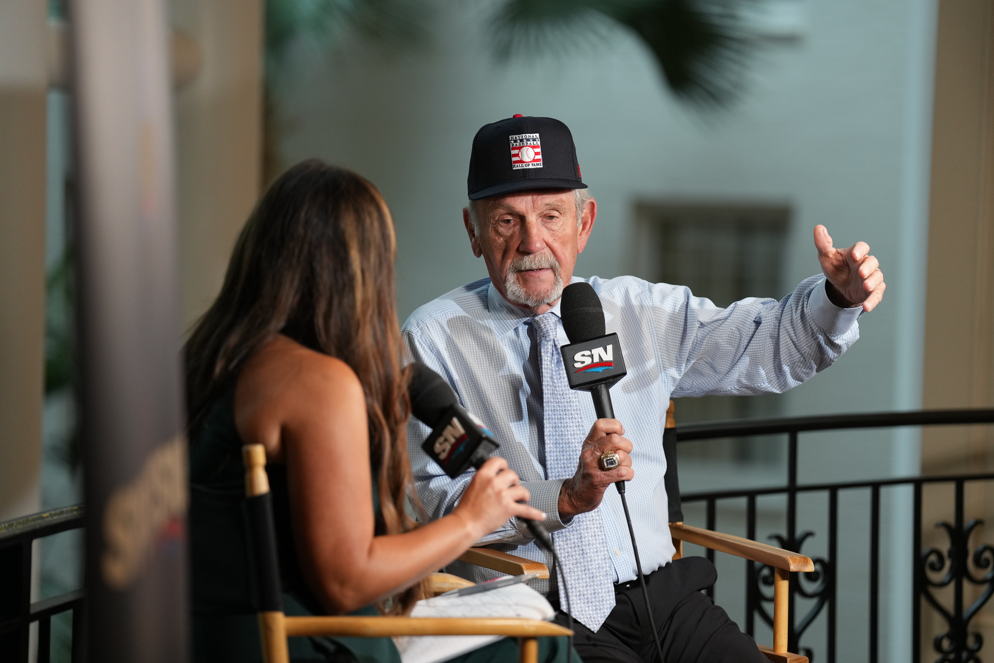 Jim Leyland talks into a microphone sitting next to a reporter
